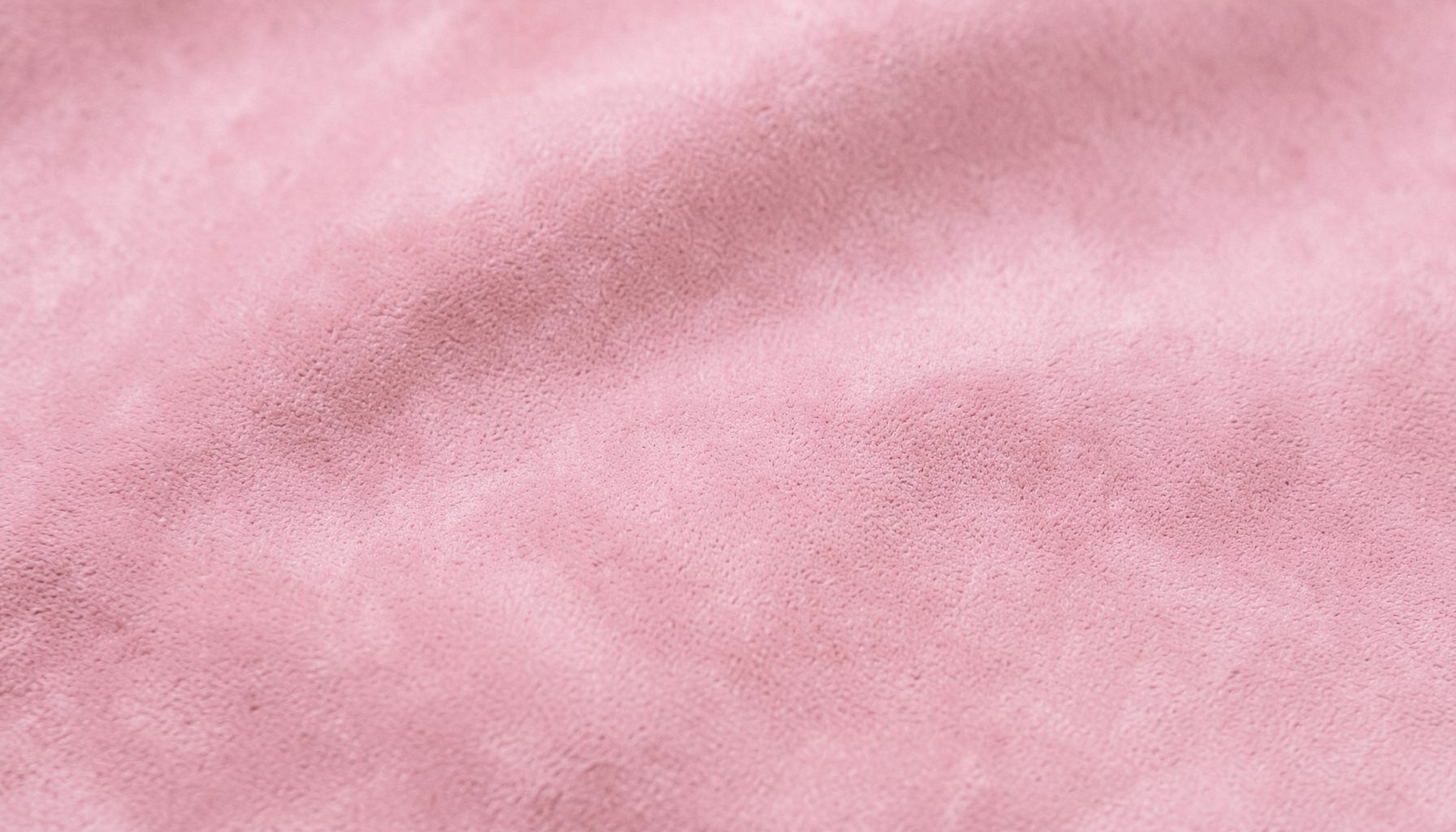 Soft pink suede-like fabric with gentle folds, warm and calm mood