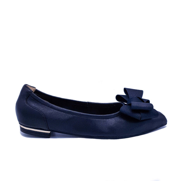 Single dark navy flat shoe with a bow detail and gold heel trim, shown in profile on a white background